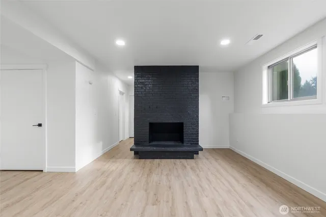 wooden floor fireplace and natural light in room