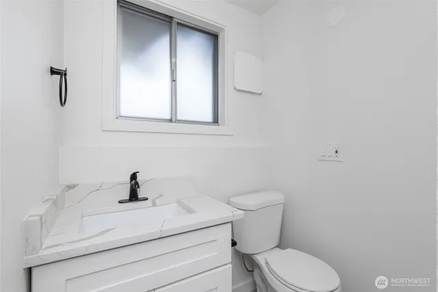 a white toilet sitting next to a bathroom sink