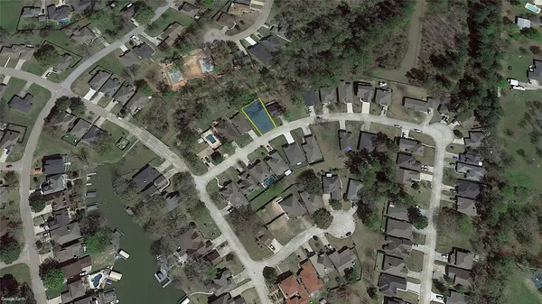 an aerial view of a residential apartment building with a yard