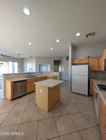 a kitchen with stainless steel appliances granite countertop a sink and cabinets