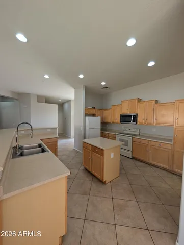 a kitchen with stainless steel appliances a sink a stove top oven and cabinets