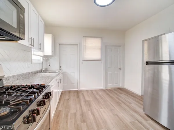 a kitchen with a refrigerator stove and a sink