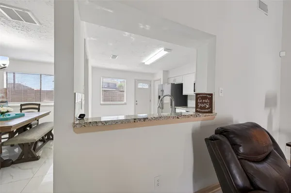 a dining room with furniture and a flat screen tv