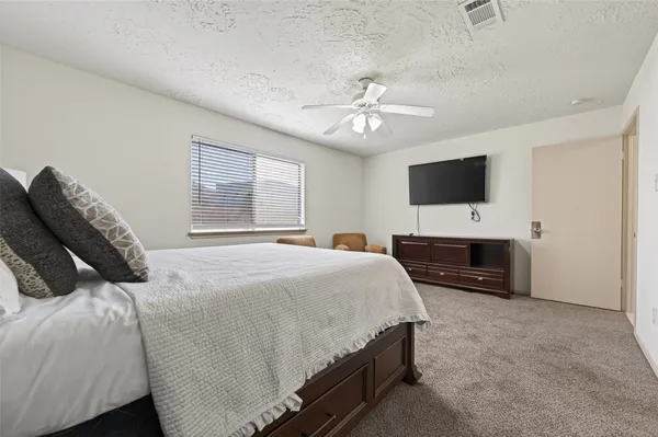 a bedroom with a bed and a flat screen tv