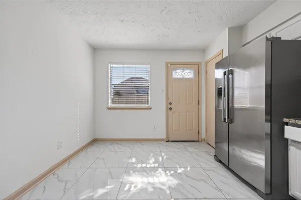 a view of empty room with wooden floor and closet