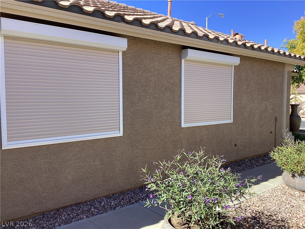 2135 Hidden Ranch Terrace Henderson, NV 89052 - Photo 25 of 27 Protective roll-down shutters enhance the security and privacy of this stucco-clad exterior.