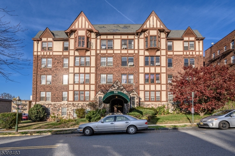 a view of a car parked in front of a brick house