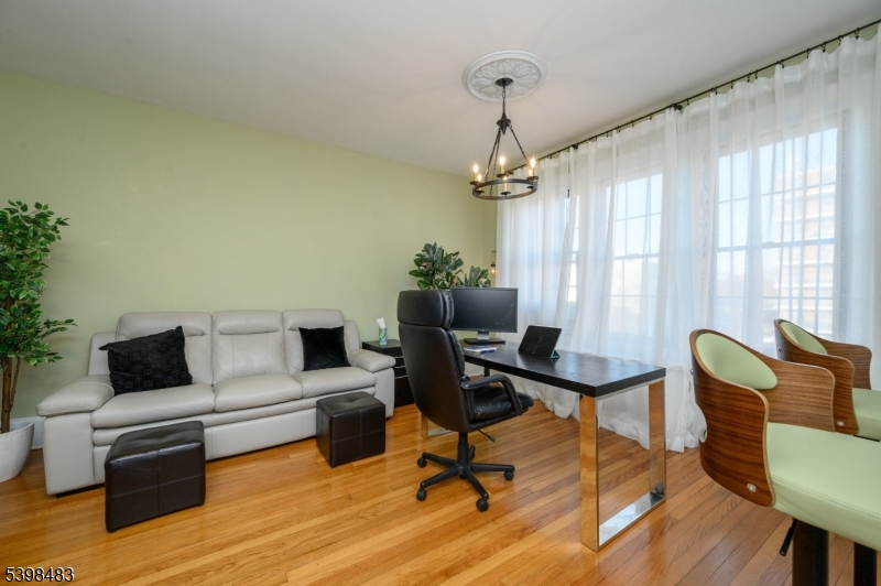55 Randolph Place, Unit 301 South Orange, NJ 07079 - Photo 12 of 23 a view of a livingroom with workspace and a couch
