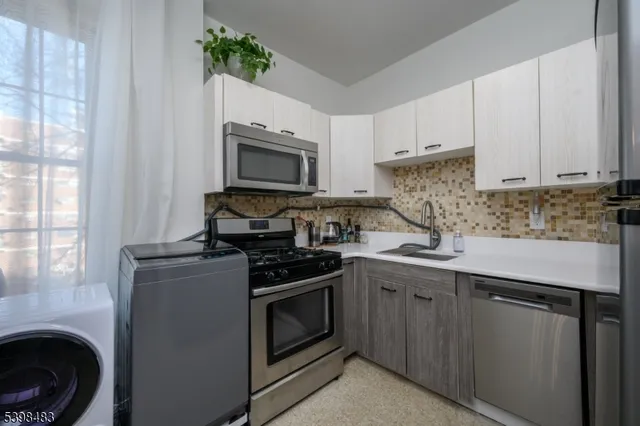 a kitchen with a sink appliances and cabinets