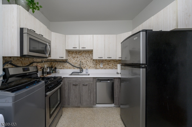 55 Randolph Place, Unit 301 South Orange, NJ 07079 - Photo 14 of 23 a kitchen with a sink appliances and cabinets