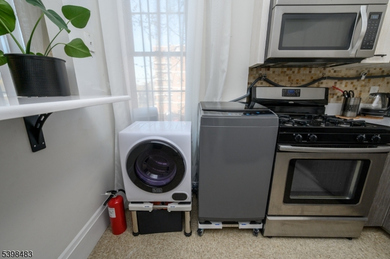 55 Randolph Place, Unit 301 South Orange, NJ 07079 - Photo 15 of 23 a living room with furniture and a fireplace