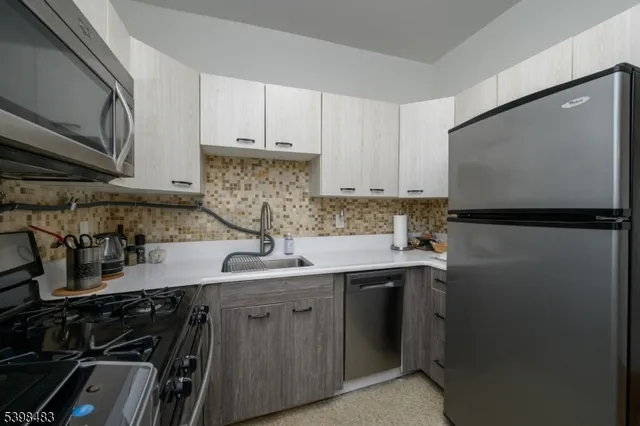 a kitchen with stainless steel appliances a stove a microwave and cabinets