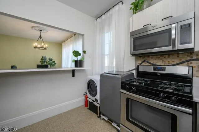 a view of kitchen with refrigerator and window