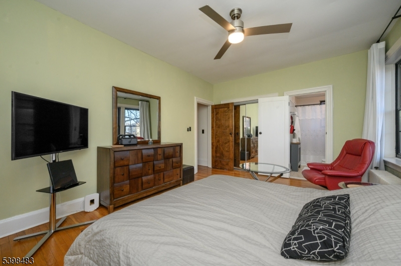55 Randolph Place, Unit 301 South Orange, NJ 07079 - Photo 20 of 23 a bedroom with a bed and a flat screen tv