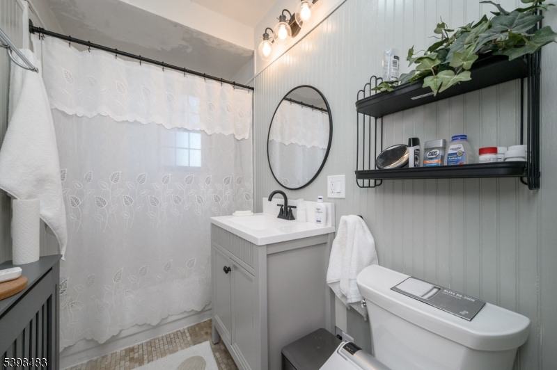 55 Randolph Place, Unit 301 South Orange, NJ 07079 - Photo 21 of 23 a bathroom with a toilet a sink and a mirror