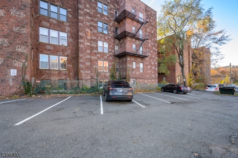 55 Randolph Place, Unit 301 South Orange, NJ 07079 - Photo 23 of 23 a car parked in front of brick building