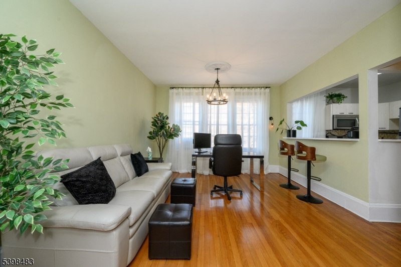 55 Randolph Place, Unit 301 South Orange, NJ 07079 - Photo 5 of 23 a living room with furniture and a chandelier