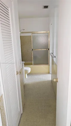 a bathroom with a glass door shower