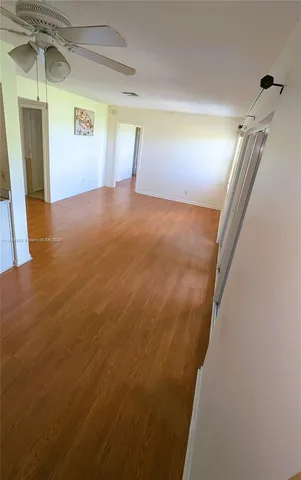 a view of a big room with wooden floor and staircase