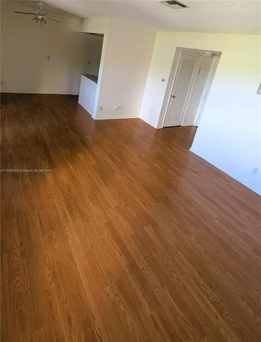 an empty room with wooden floor