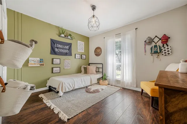 a bedroom with a bed and a table in it