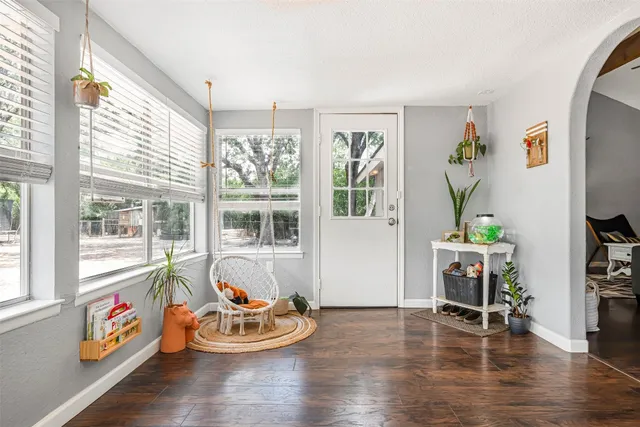 a dining room with wooden floor and a window