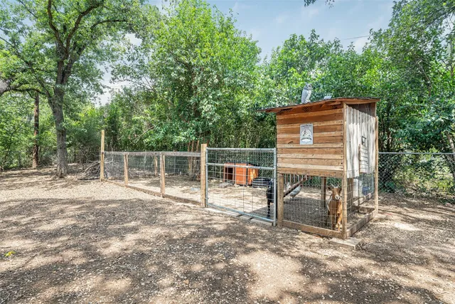 a backyard of a house with table and chairs