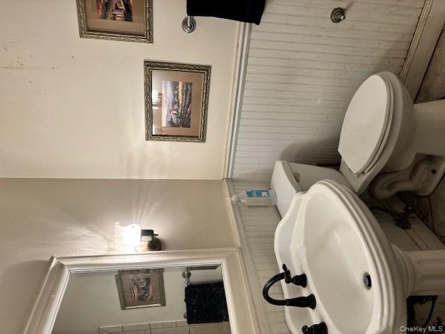 761 East Main Street Riverhead, NY 11901 - Photo 17 of 22 a bathroom with a sink and a toilet