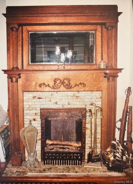 761 East Main Street Riverhead, NY 11901 - Photo 6 of 22 a view of a fireplace with a mirror