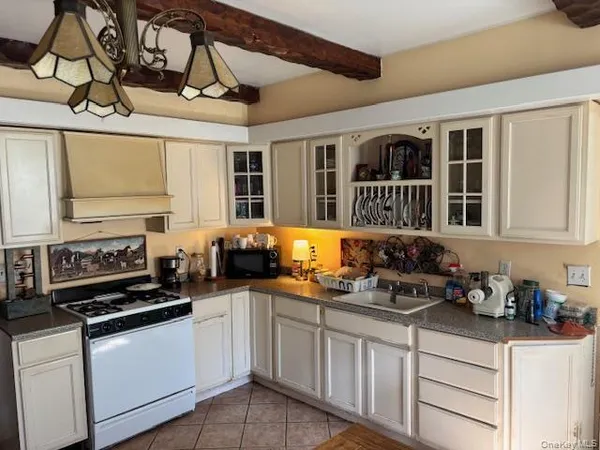 a kitchen with stainless steel appliances a stove a sink and cabinets