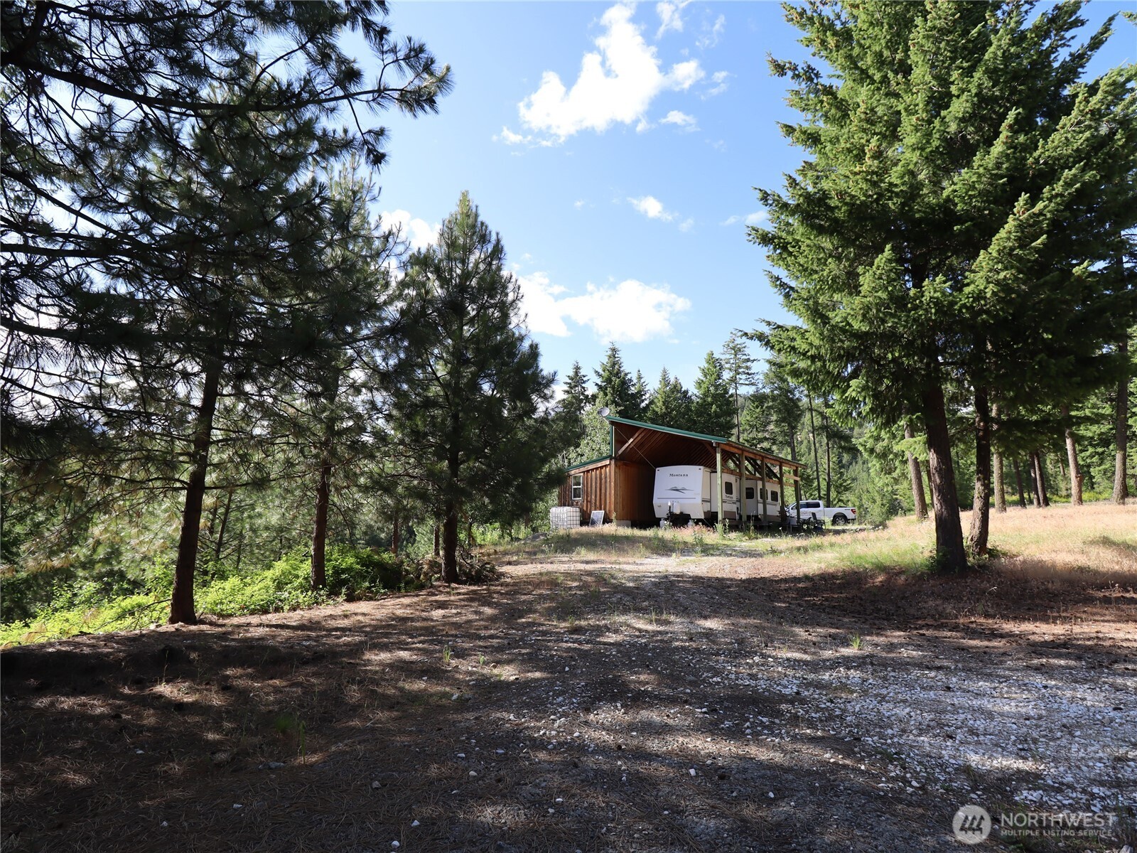 1733 Old CC Road Addy, WA 99101 - Photo 8 of 32 a front view of a house with yard and trees