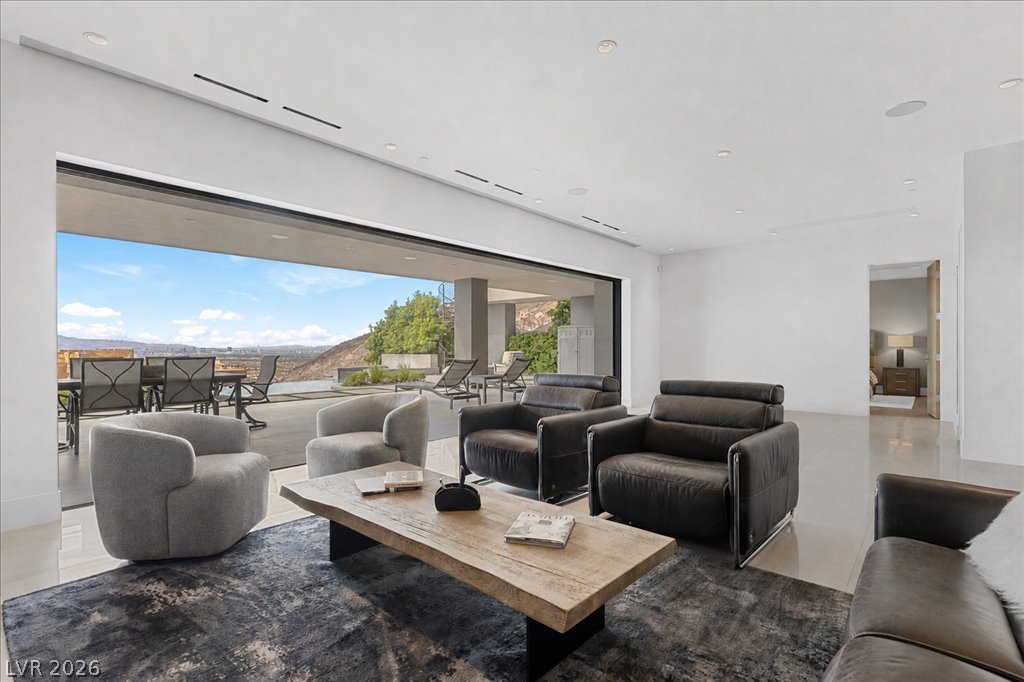 657 Ridgestone Rim Court Henderson, NV 89012 - Photo 57 of 97 Retractable glass doors connect polished tile floors directly to an expansive outdoor terrace.