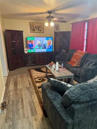 a living room with furniture and a flat screen tv