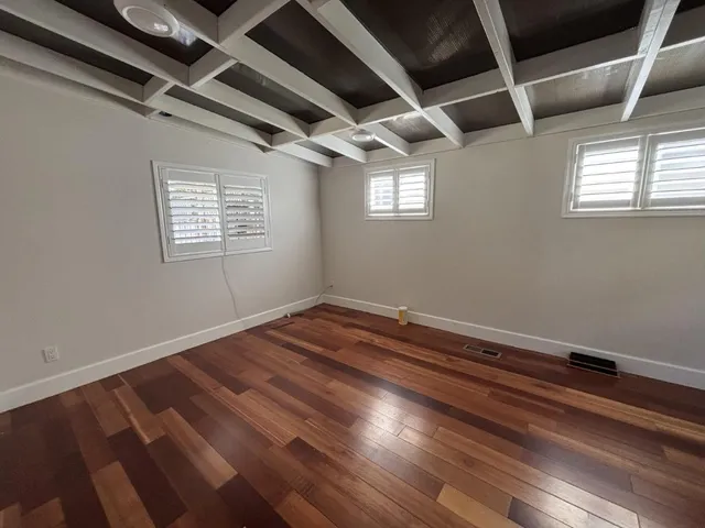 a view of room with window and wooden floor