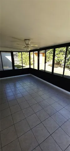 a view of an empty room with windows