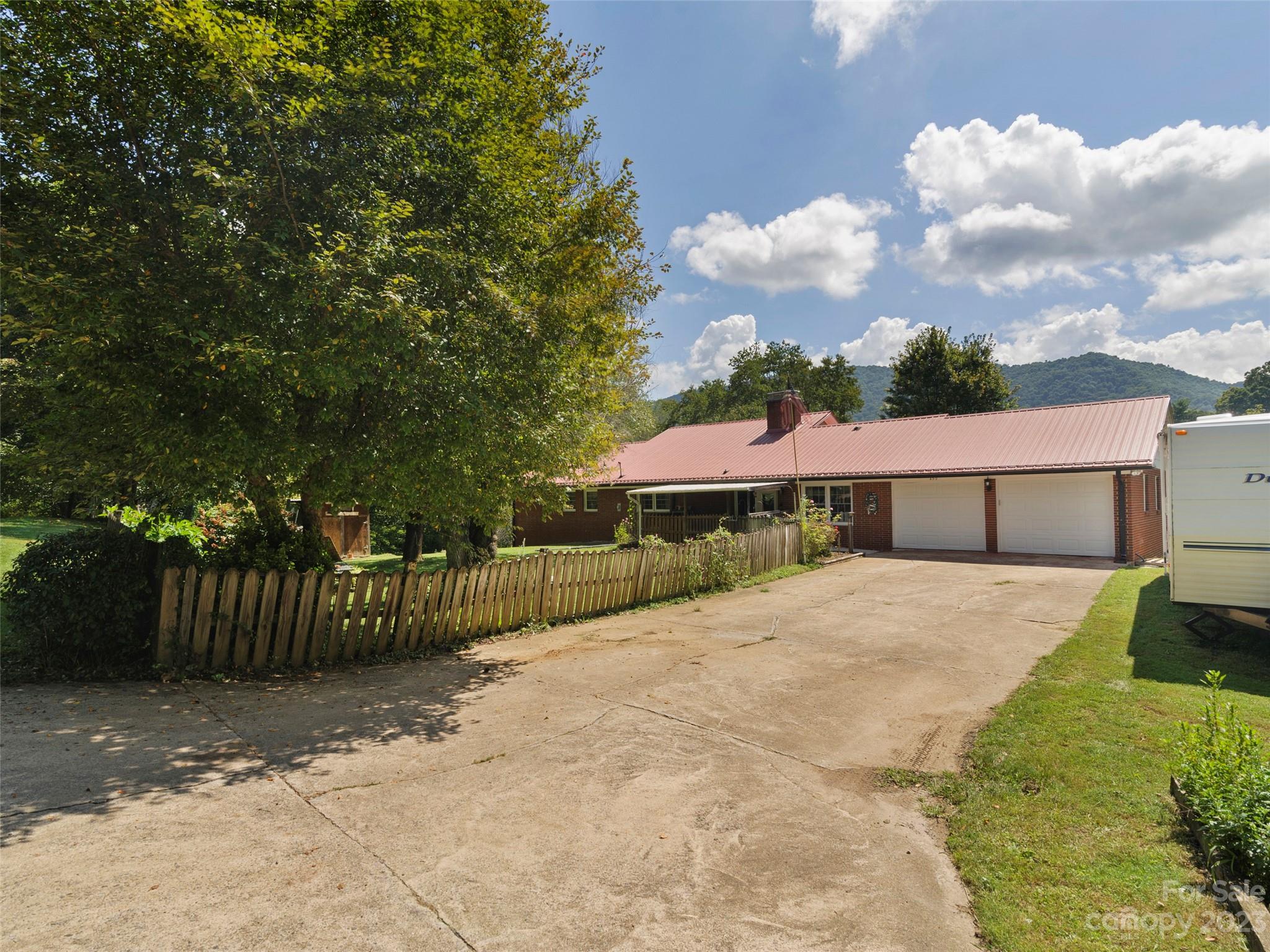 450 Chambers Road Waynesville, NC 28786 - Photo 1 of 28 a view of a house with wooden fence