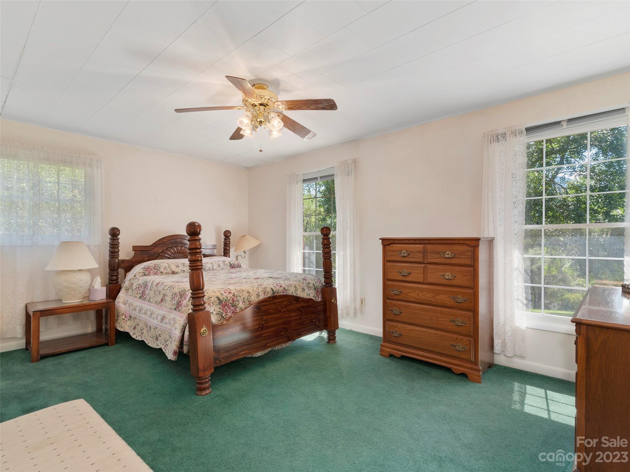 450 Chambers Road Waynesville, NC 28786 - Photo 15 of 28 a bedroom with a bed and a ceiling fan
