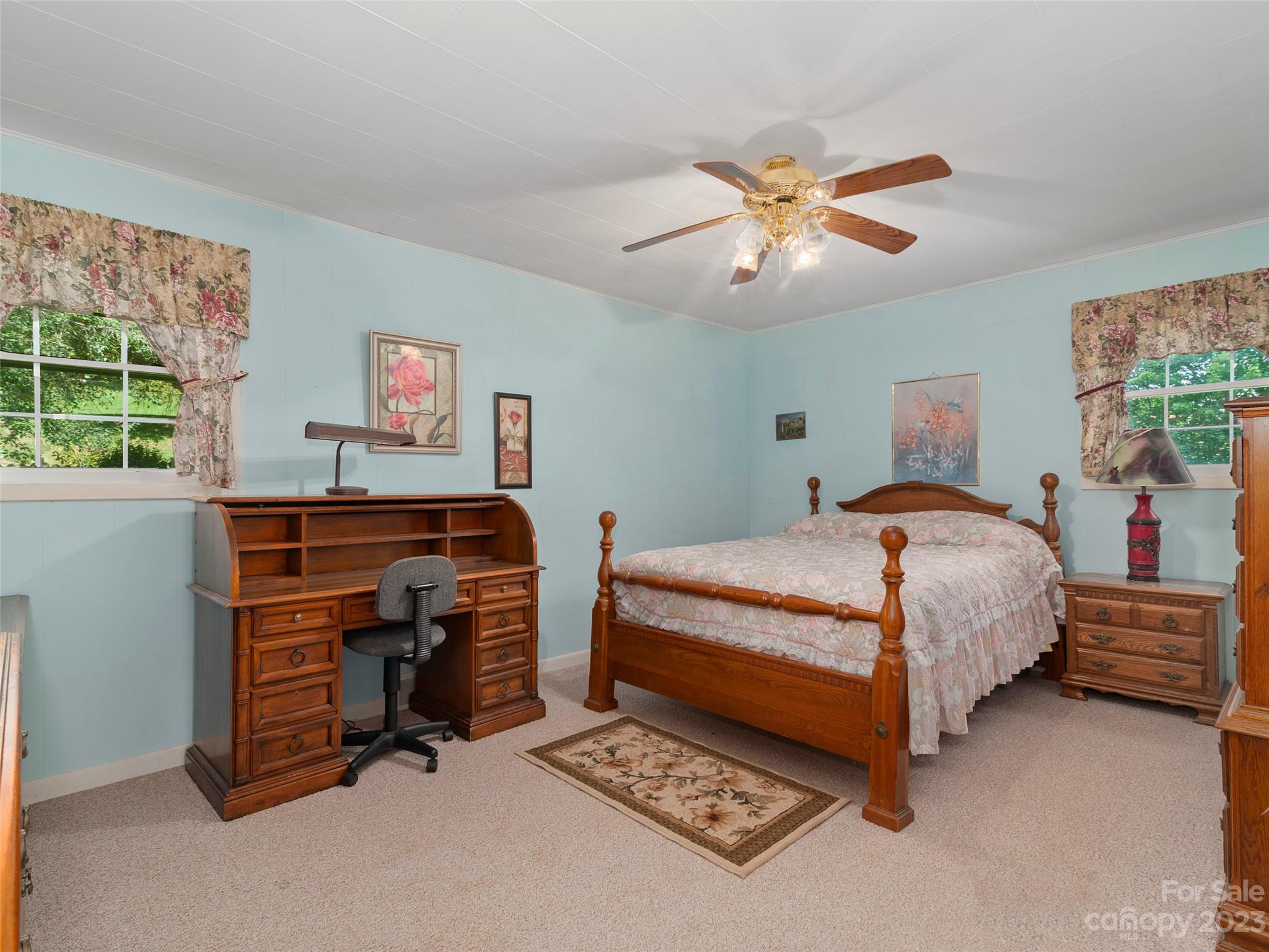 450 Chambers Road Waynesville, NC 28786 - Photo 17 of 28 a bedroom with a bed and a chandelier