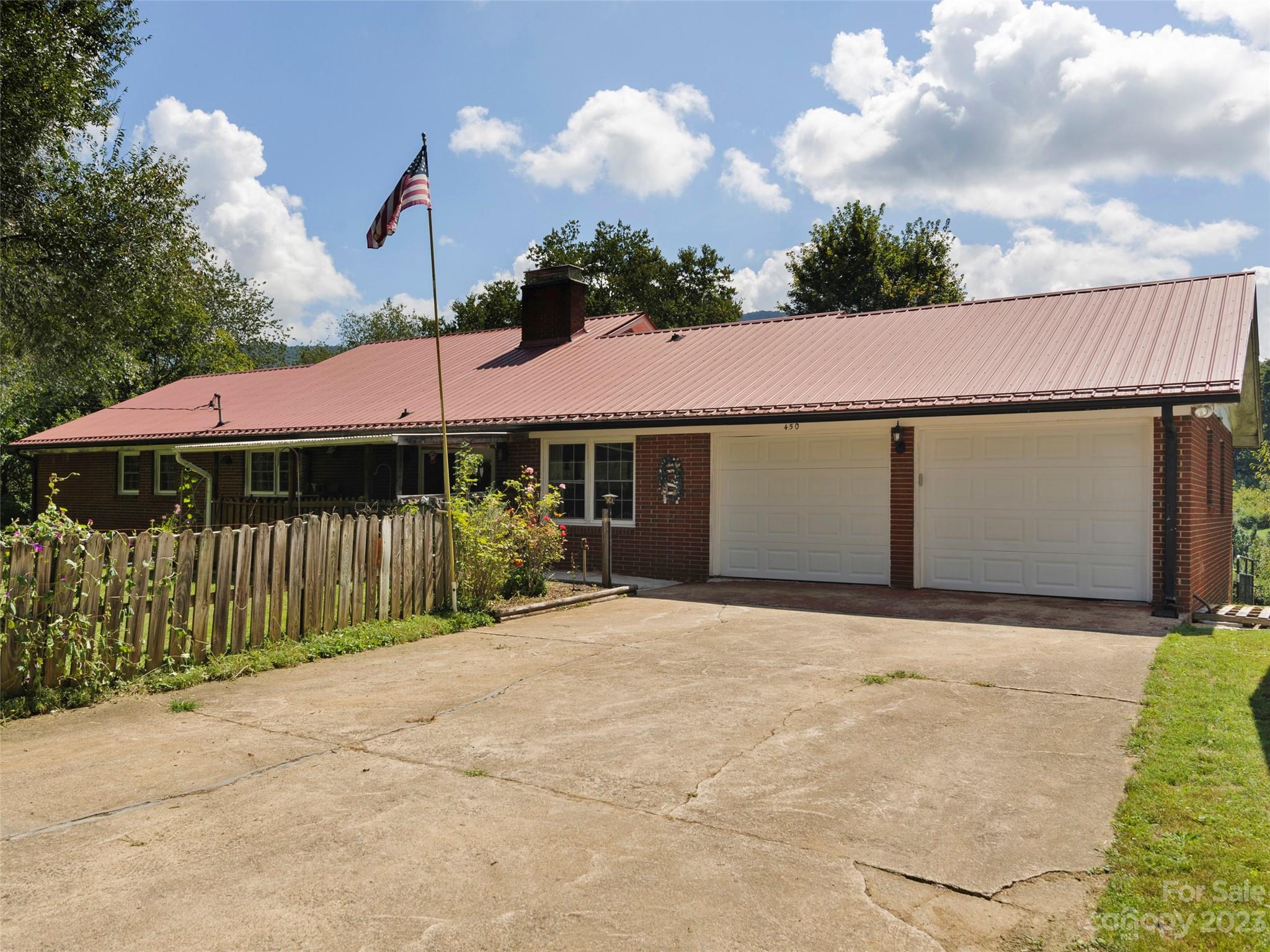 450 Chambers Road Waynesville, NC 28786 - Photo 2 of 28 a front view of a house with a yard and garage