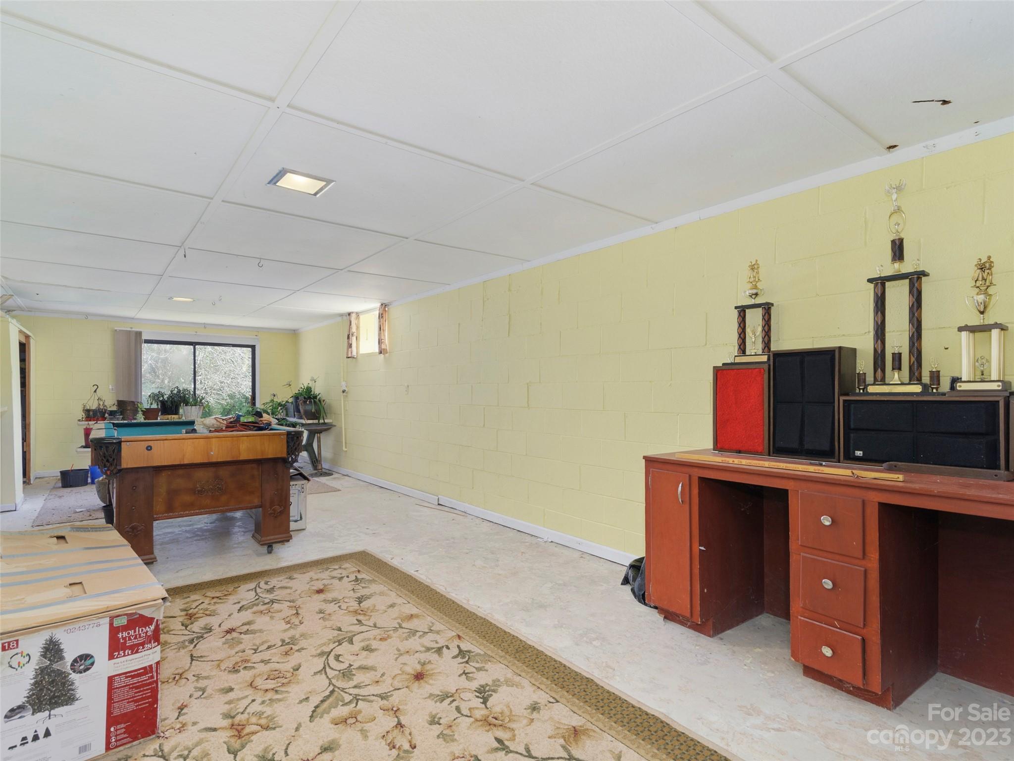 450 Chambers Road Waynesville, NC 28786 - Photo 23 of 28 a room with a wooden floor and furniture