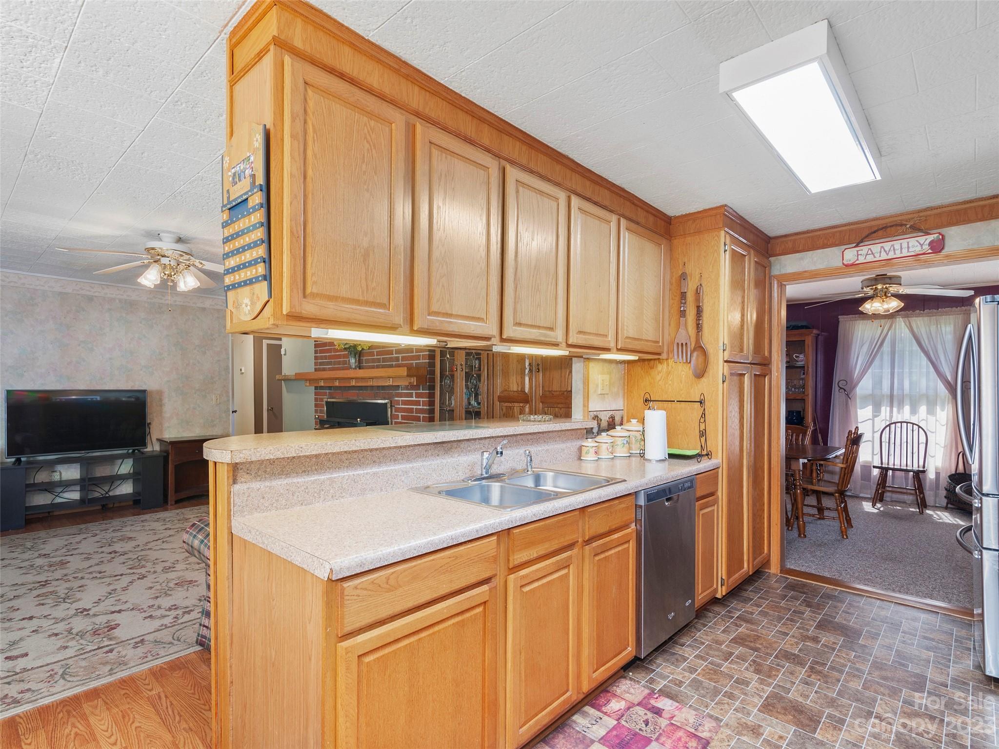 450 Chambers Road Waynesville, NC 28786 - Photo 7 of 28 a kitchen with stainless steel appliances a sink stove and cabinets