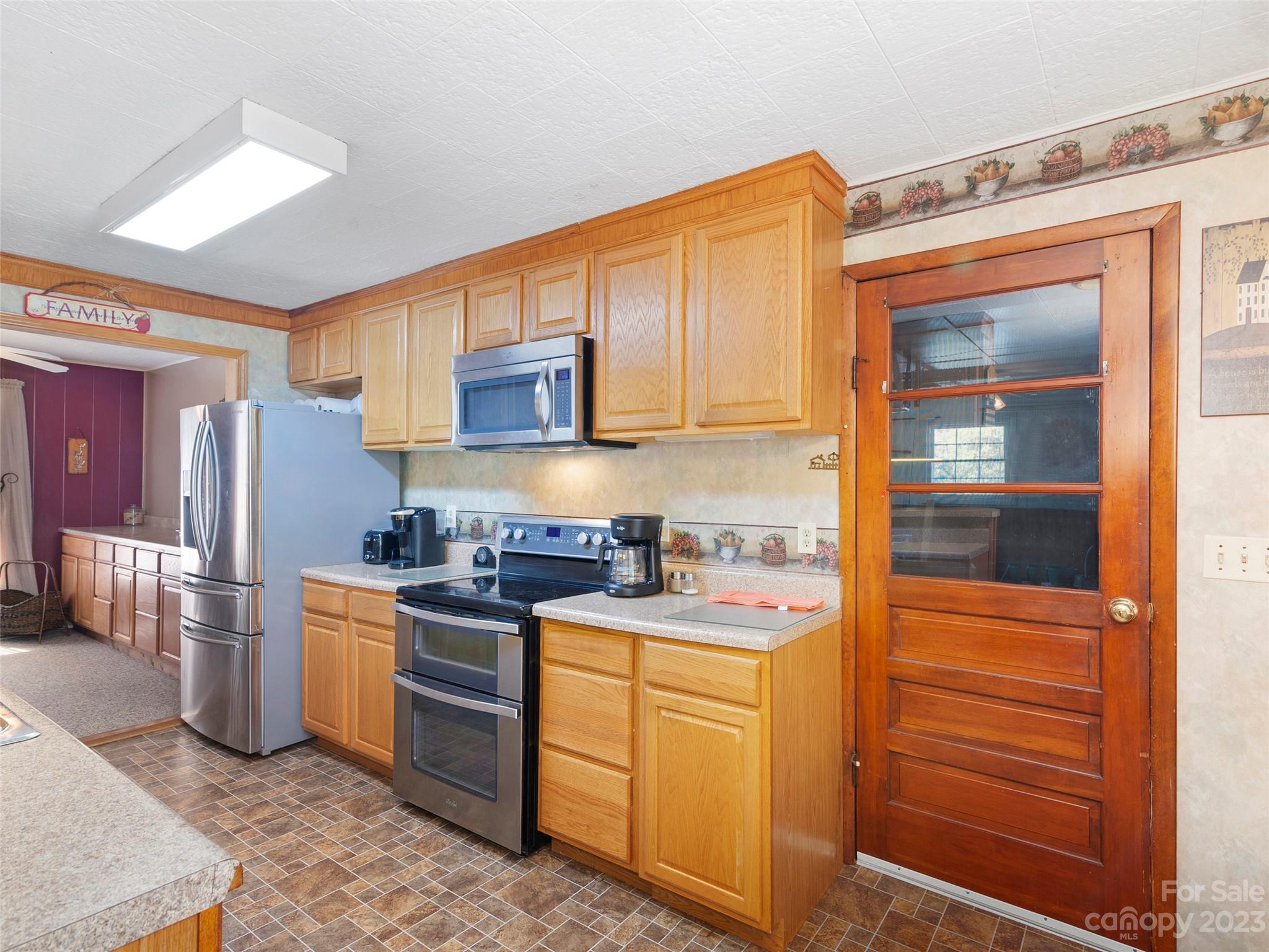450 Chambers Road Waynesville, NC 28786 - Photo 8 of 28 a kitchen with stainless steel appliances granite countertop a stove and a refrigerator