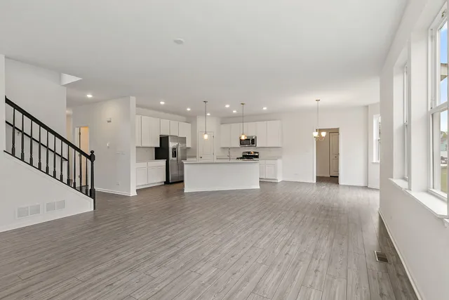 a view of kitchen with wooden floor and a window