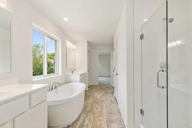 a bathroom with a tub sink and window