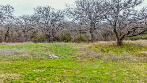 a view of outdoor space with trees all around