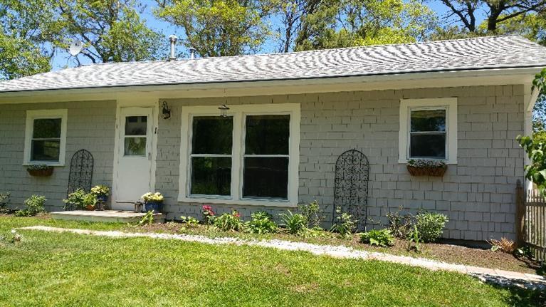 1 Pokesit Road Pocasset, MA 02559 - Photo 15 of 16 a front view of a house with a yard