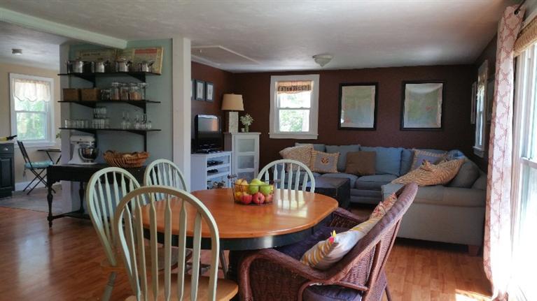 1 Pokesit Road Pocasset, MA 02559 - Photo 5 of 16 a dining room with furniture window and wooden floor