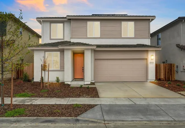 a front view of a house with garage