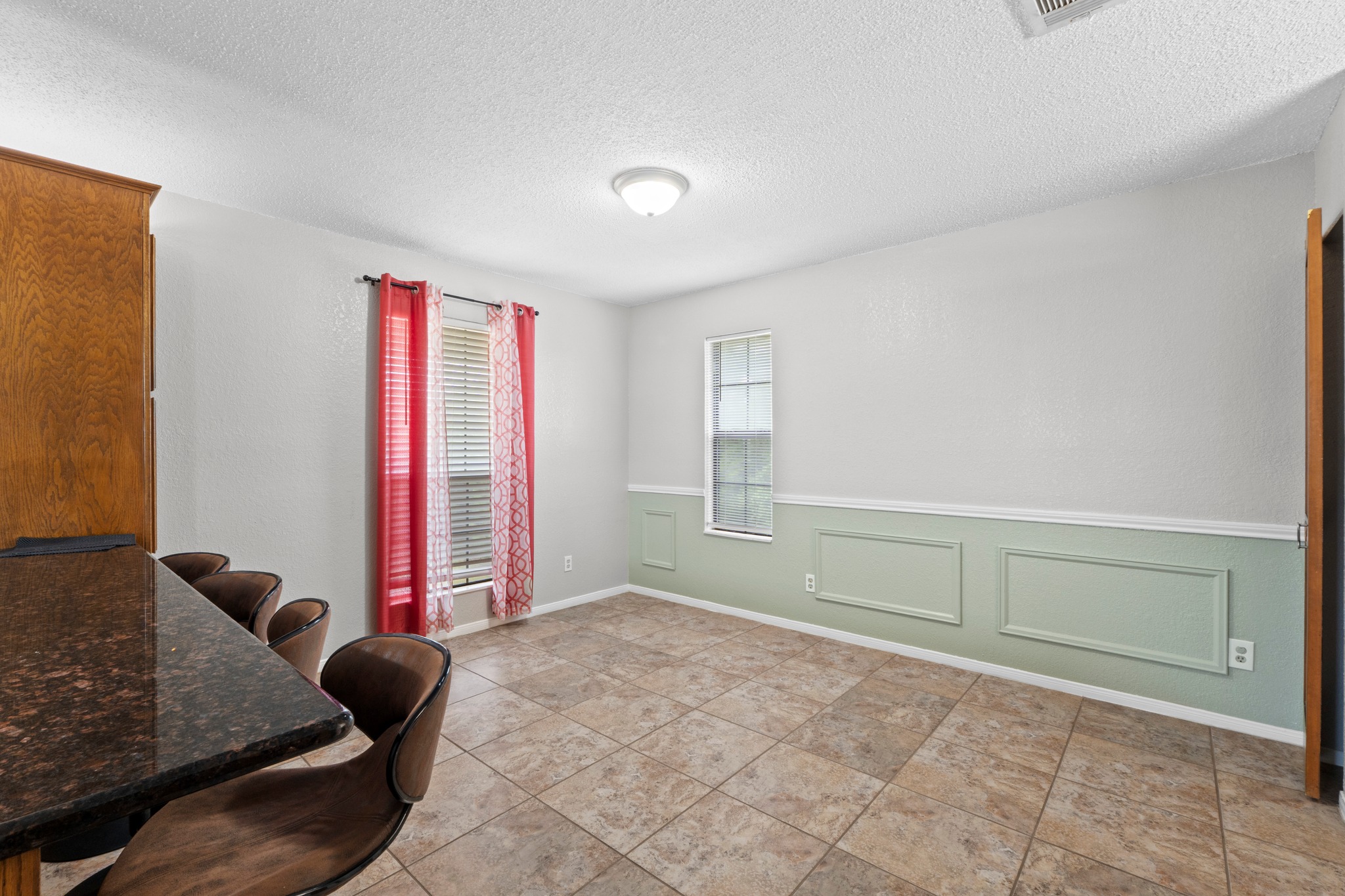 205 Sedro Trail Georgetown, TX 78633 - Photo 14 of 32 Functional breakfast area features tile flooring, a large window, and wainscoting.