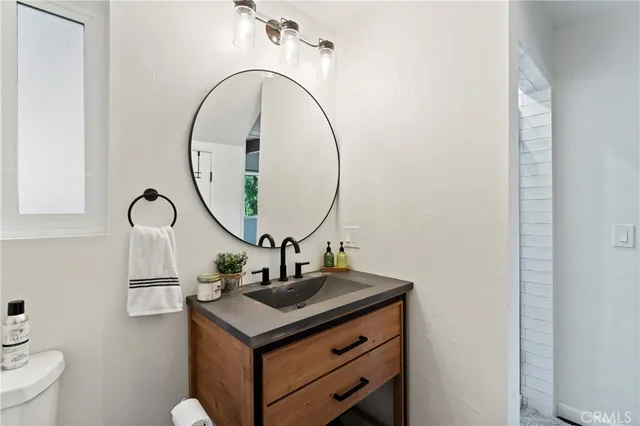a bathroom with a toilet and a shower curtain